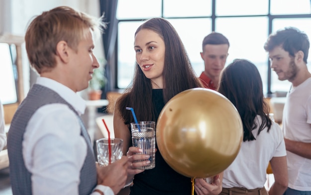 Group of young people communicate at a party.