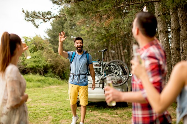 Group of young people enjoying barbecue party in the nature