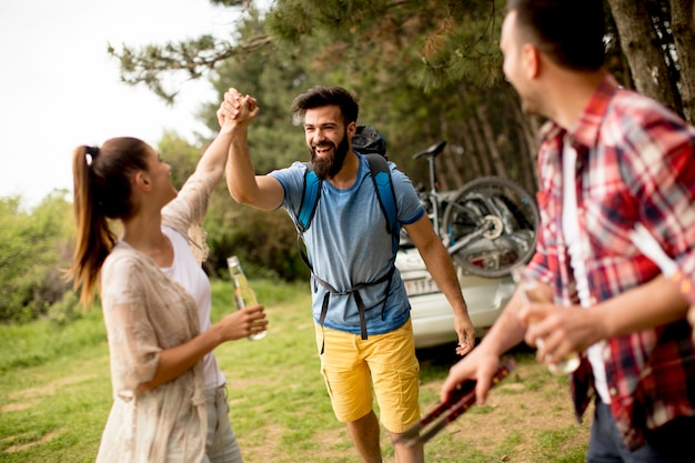 Group of young people enjoying barbecue party in the nature