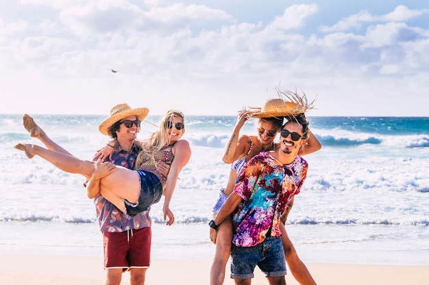 Group of young people have fun together at the beach Concept of people and summer holiday vacation Friendship and outdoor leisure activity in tropical sea scenic place