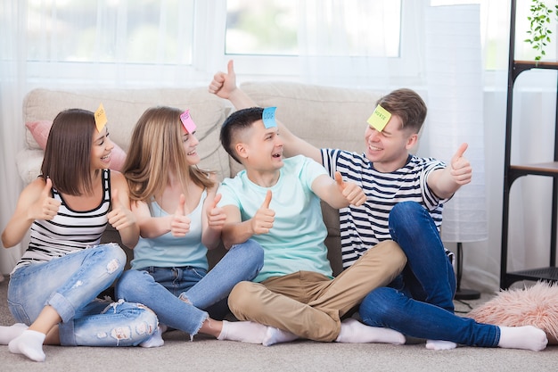 Group of young people playing games indoors. Active youth. Happy smiling people having fun. Students at the holidays.