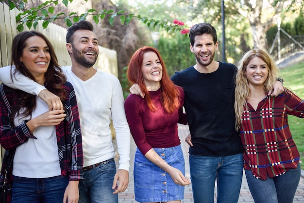 Group of young people together outdoors in urban background