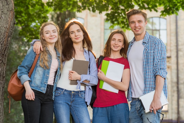 Group of young students in front of school building