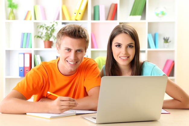 Group of young students sitting at the library