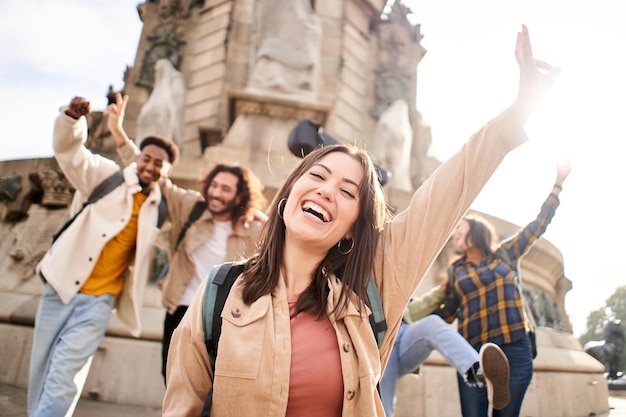 Group of young students of university celebrating success Young people cheerful friends looking at the camera with arms up