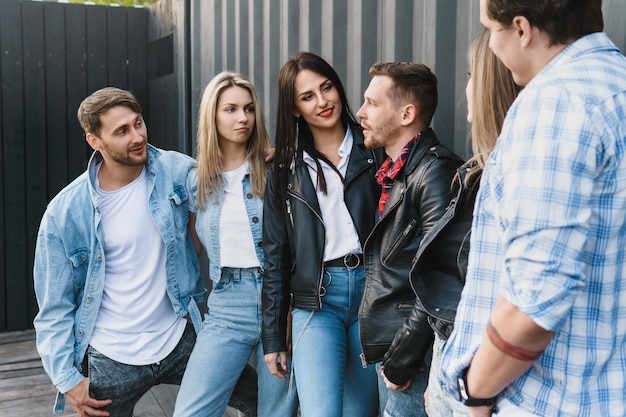 Group of young and stylish friends during a meeting on a city street