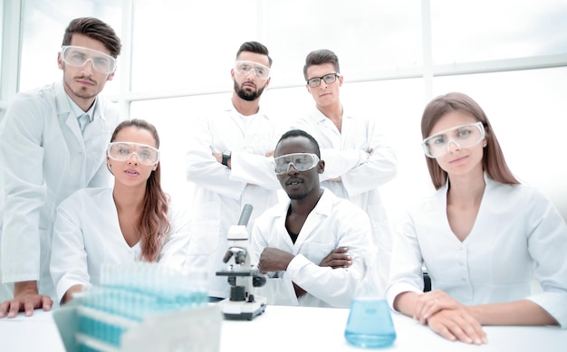 Group of young successful scientists posing for camera