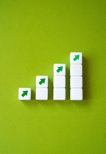 Photo growing graph made of blocks and up arrows steps of growth enlargement and growth concept