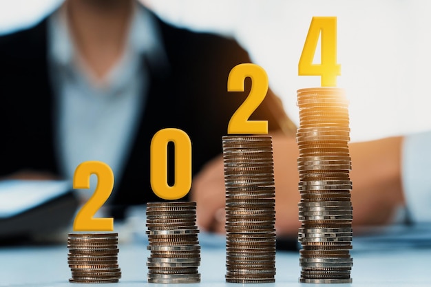 Growth coin stack symbolizing business investment and economic growth Business people doing financial planning to achieve financial goal and contribute maximum profit on new year 2024 Shrewd