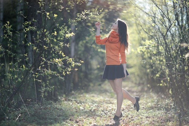 growth portrait of young adult woman on nature in the park