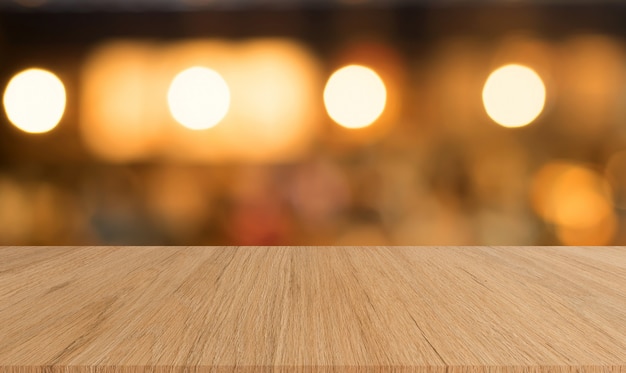 grungy brown wood panel tabletop with blurred restaurant bar cafe light color background 