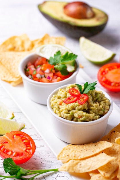 Guacamole, tomato sauce salsa and chips nachos