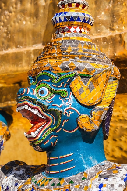 Guardian demon holding Golden Chedi of Wat Phra Kaew Temple in Bangkok, Thailand