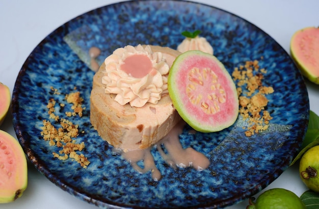 Guava Roll Cake on blue plate on light background with ripe guava fruit