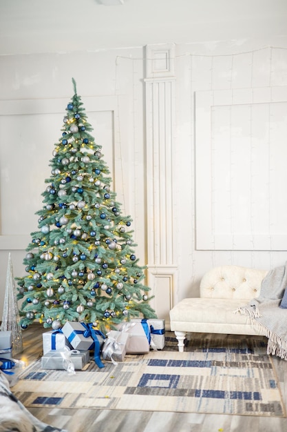 The guest room is decorated for Christmas a tree with gifts and toys Christmas balls