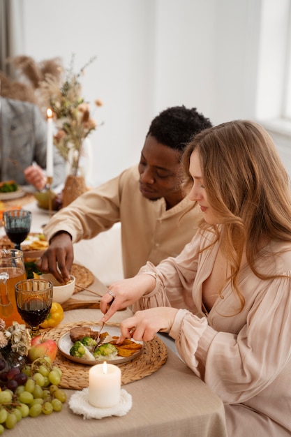 Guests attending wedding and eating at the table