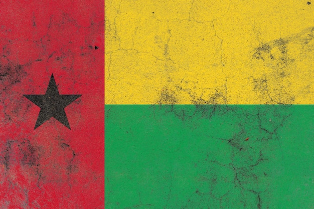 Guinea bissau flag on a cracked old concrete wall