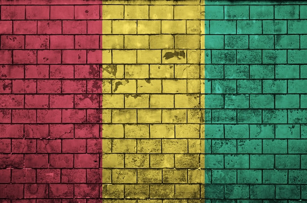 Guinea flag is painted onto an old brick wall