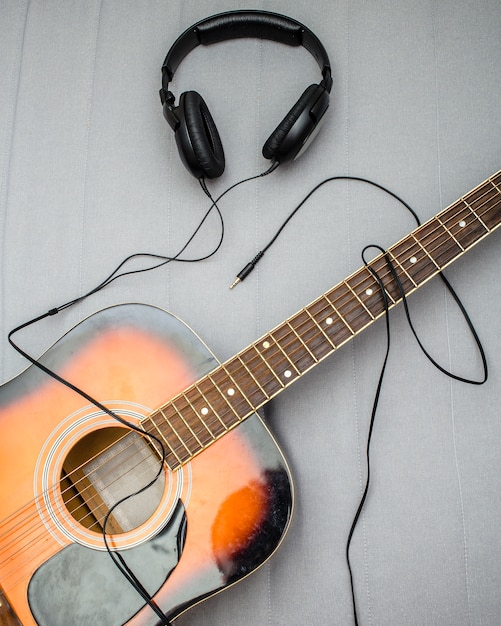 Guitar, headphones, silhouette of a guitarist playing