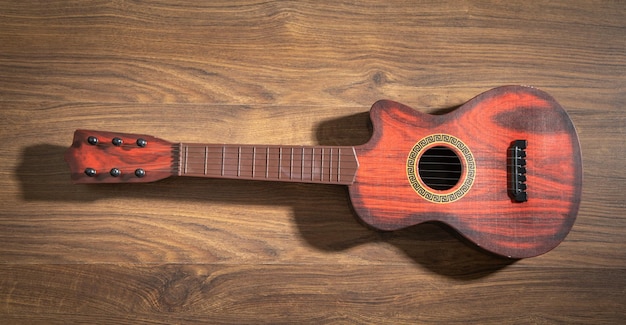 Guitar on the wooden background