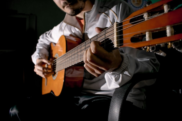 Guitarist hands and guitar close up. Playing classic guitar. Play the guitar.