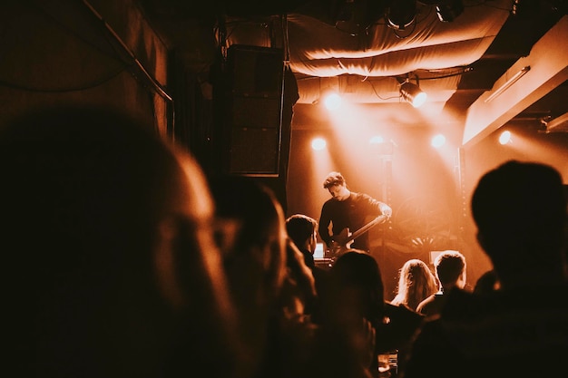 Photo guitarist playing an electric guitar in a concert