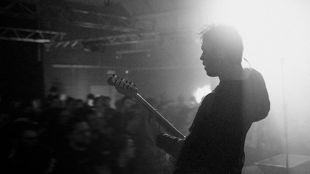 Guitarist playing electric guitar in a rock concert