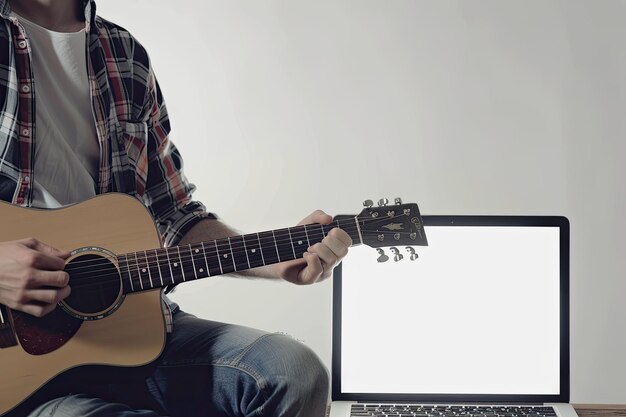 Photo guitarist playing his acoustic instrument next to greenscreen on laptop