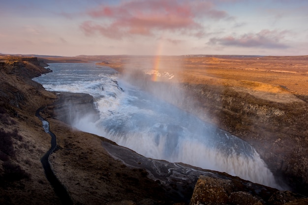 Gullfoss waterfall in Iceland Sunset with Rainbow and cloudy day