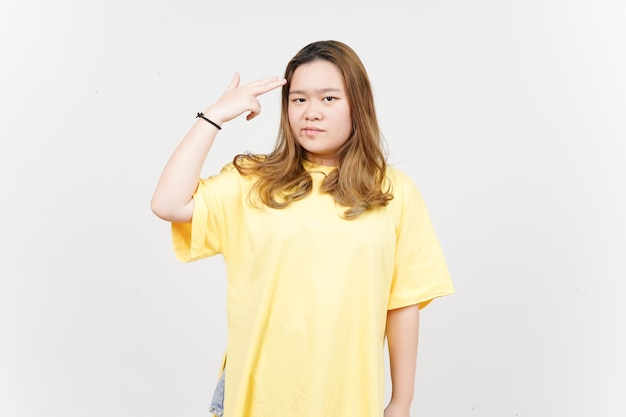 Gun finger on head of Beautiful Asian Woman wearing yellow TShirt Isolated On White Background