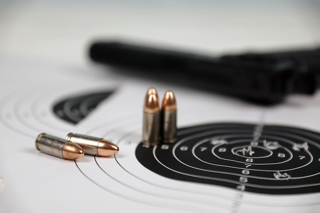 Gun and many bullets shooting targets on white table in shooting range polygon Training for aiming and shooting