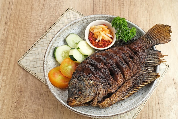 Gurame Bakar Madu, Grilled Gourami with honey and soy sauce. Served with sambal (chilli sauce).