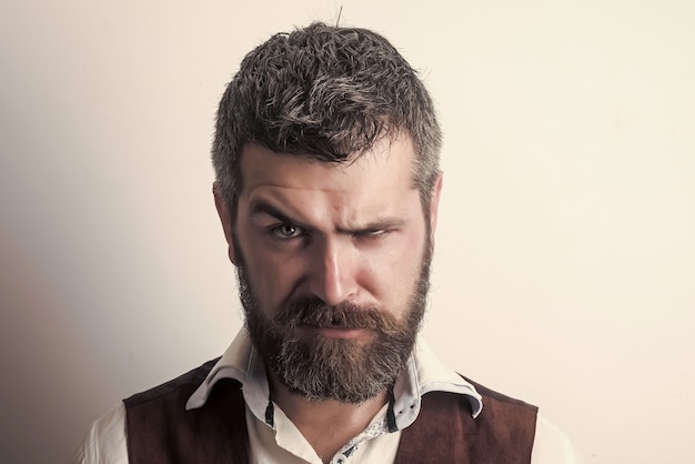 Guy or bearded man. Hipster with stylish hair beard. Barber fashion and beauty. Man with long beard and mustache on serious face.