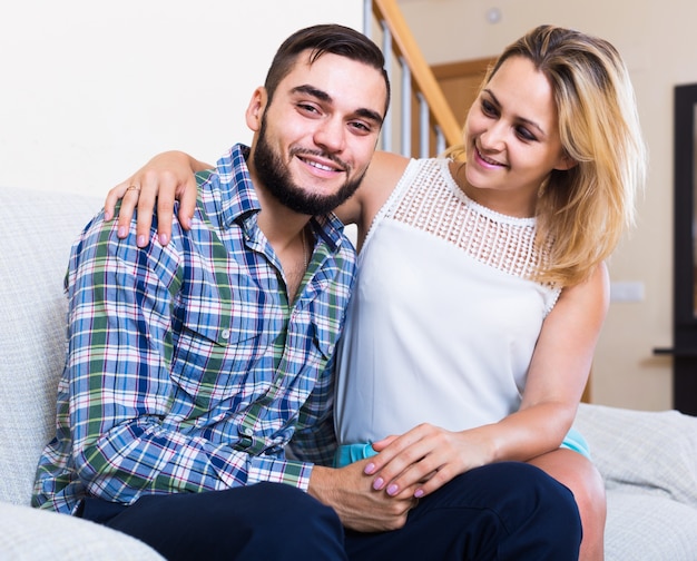  guy and cheerful pretty girl smiling indoors