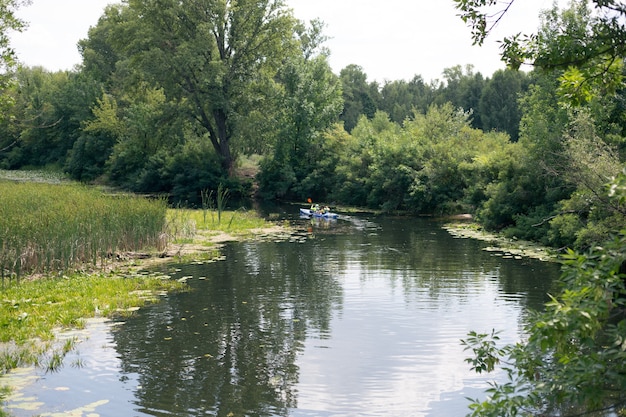 A guy and a girl canoe paddling the river