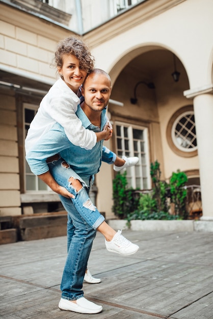 Guy and a girl happily walk in the morning on the empty streets of old Europe