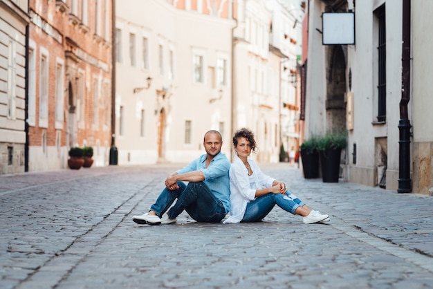 Guy and a girl happily walk in the morning on the empty streets of old Europe