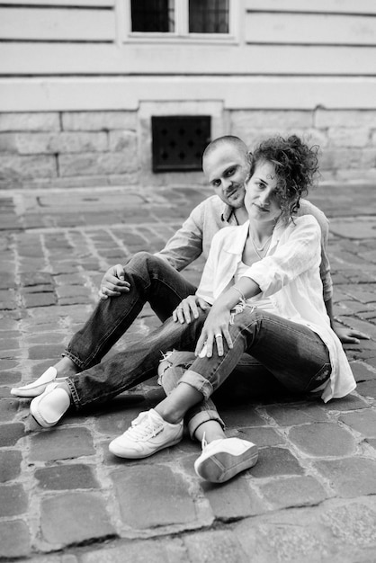 Guy and a girl happily walk in the morning on the empty streets of old Europe