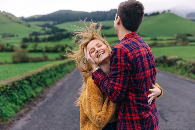 Guy and girl hug The girl looks at the camera and smiles mount