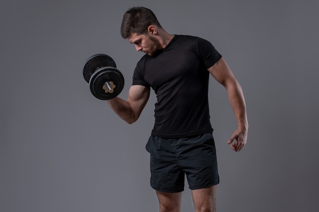 guy performing biceps curl with dumbbell