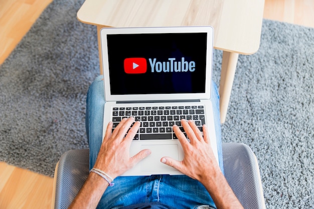 Guy sitting and watching at laptop