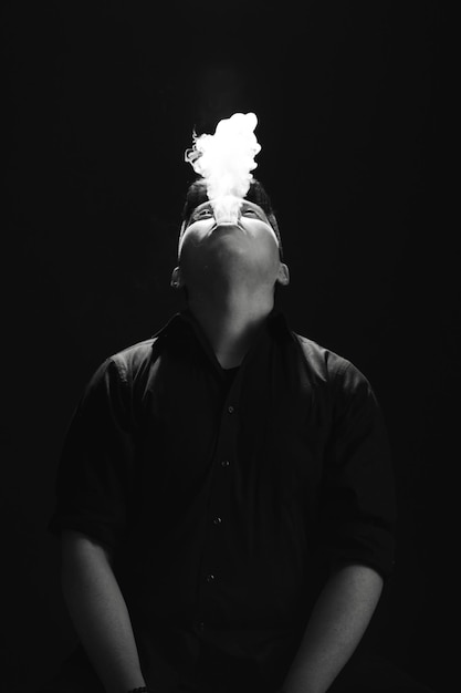 guy smoking on black background in photo studio