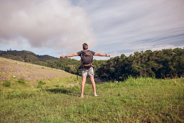 guy with a backpack on top of the trail