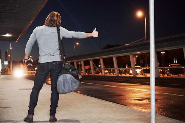 Guy with blonde hair trying to catch the car