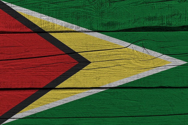 Guyana flag painted on old wood plank