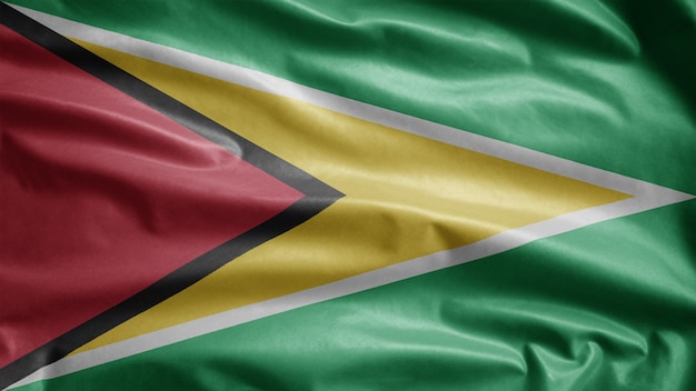 Guyanese flag waving in the wind. Close up of Guyana banner blowing, soft and smooth silk. Cloth fabric texture ensign background. Use it for national day and country occasions concept.