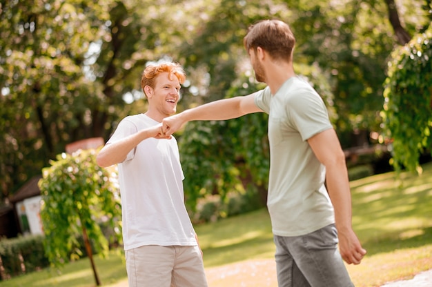 Guys greeting each other with touch of fist