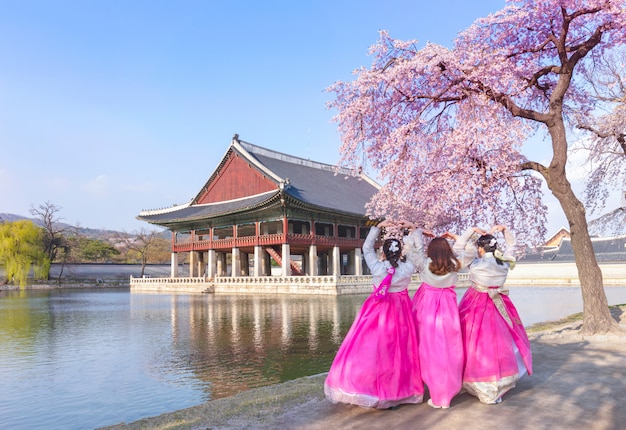 Gyeongbokgung Palace with Korean national dress and cherry blossom in spring,Seoul,South lKorea.