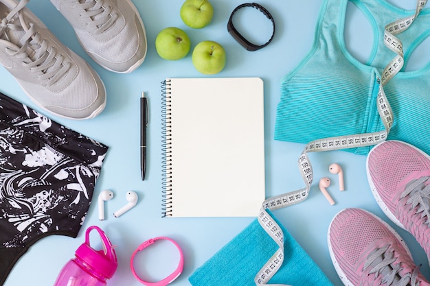 Gym wear and accessories for women with blank notebook for exercise plan