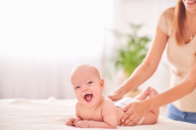 Gymnastics baby. massage a small newborn baby.